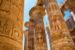Close-up of ancient Egyptian columns with intricate carvings at Karnak Temple in Luxor.